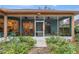 Inviting screened patio adorned with plants and vibrant blooms, complemented by glimpses of the kitchen and dining area at 19586 Sw 84Th Pl, Dunnellon, FL 34432