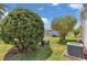 Backyard with mature landscaping and the AC unit at 2608 Botello Ave, The Villages, FL 32162