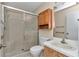 Well-lit bathroom with a shower, vanity, and medicine cabinet at 2608 Botello Ave, The Villages, FL 32162