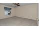 Spacious carpeted bedroom with a ceiling fan and window at 2608 Botello Ave, The Villages, FL 32162