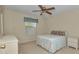 Bedroom featuring a ceiling fan, a bed, and a window at 2608 Botello Ave, The Villages, FL 32162