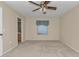 Large carpeted bedroom with a ceiling fan and a view of an ensuite bathroom at 2608 Botello Ave, The Villages, FL 32162