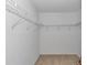 Walk-in closet featuring shelving for easy storage and organization at 2608 Botello Ave, The Villages, FL 32162