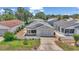 Charming single-story home with a well-manicured lawn, beautiful landscaping and white picket fence at 2608 Botello Ave, The Villages, FL 32162