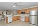 Kitchen with wooden cabinetry, stainless steel appliances, and a functional layout with an open design at 2608 Botello Ave, The Villages, FL 32162