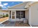 Sunroom with a cozy seating area, with bright natural light coming through the windows and door at 2608 Botello Ave, The Villages, FL 32162