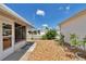 Landscaped side yard featuring rock cover, a white picket fence, and small shrubs at 2608 Botello Ave, The Villages, FL 32162