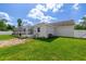 Exterior home view with a screened-in pool and a large, grassy lawn at 2671 Sw 158Th Lane Rd, Ocala, FL 34473