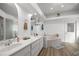 Bathroom with dual sinks, granite counters, decorative shelving, and a soaking tub at 2671 Sw 158Th Lane Rd, Ocala, FL 34473