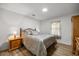 Cozy bedroom with wood-look floors, large bed, and window with sheer curtains at 2671 Sw 158Th Lane Rd, Ocala, FL 34473