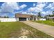 Well-kept home exterior with a long driveway and attached two-car garage at 2671 Sw 158Th Lane Rd, Ocala, FL 34473