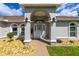 Covered front entryway with decorative rock landscaping and a charming facade at 2671 Sw 158Th Lane Rd, Ocala, FL 34473