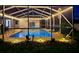 Backyard pool and patio at twilight, surrounded by tropical landscaping and cozy lighting at 2671 Sw 158Th Lane Rd, Ocala, FL 34473