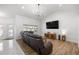 Cozy living room with wood floors, vaulted ceilings, a modern chandelier, and natural light at 2671 Sw 158Th Lane Rd, Ocala, FL 34473