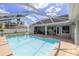 Screened pool with an outdoor patio and grill, ideal for entertaining guests at 2671 Sw 158Th Lane Rd, Ocala, FL 34473