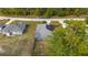 Aerial view of a home featuring solar panels, an adjacent fenced backyard, and a neighboring property at 30 Bahia Trace Loop, Ocala, FL 34472