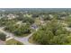 An aerial view shows the home with verdant tree cover, situated in a peaceful and established neighborhood at 30 Bahia Trace Loop, Ocala, FL 34472
