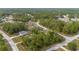 A serene aerial view showcases the property nestled among lush green trees in a quiet residential neighborhood at 30 Bahia Trace Loop, Ocala, FL 34472