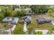 Aerial view of a home showcasing its well-maintained lawn, solar panels, and proximity to neighboring properties at 30 Bahia Trace Loop, Ocala, FL 34472