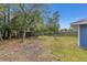 A backyard with lawn, trees, and a wood fence at 30 Bahia Trace Loop, Ocala, FL 34472