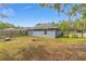 Backyard featuring a lawn, perimeter wood fence, fire pit and pergola at 30 Bahia Trace Loop, Ocala, FL 34472
