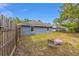 Backyard featuring a lawn, wood fence, fire pit, and mature trees at 30 Bahia Trace Loop, Ocala, FL 34472