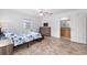 Comfortable bedroom boasts ceiling fan, dresser and ensuite bathroom at 30 Bahia Trace Loop, Ocala, FL 34472