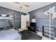 Nice bedroom features a bunk bed, ceiling fan and dark blue accent wall at 30 Bahia Trace Loop, Ocala, FL 34472