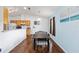 Bright dining room with wood floors, stylish dining table, and open access to the kitchen at 30 Bahia Trace Loop, Ocala, FL 34472