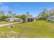 Attractive single-story home featuring a green lawn, a cozy front porch, and a paved driveway at 30 Bahia Trace Loop, Ocala, FL 34472