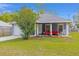 Inviting home featuring a cozy front porch seating area, landscaped garden bed, and ample natural light at 30 Bahia Trace Loop, Ocala, FL 34472
