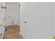 A hallway with tile floors, a white door, and a laundry area with washer and dryer at 30 Bahia Trace Loop, Ocala, FL 34472