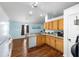 Charming kitchen features granite counters, wood cabinets and stainless sink at 30 Bahia Trace Loop, Ocala, FL 34472