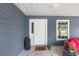 Covered patio with seating and decor next to a door and window at 30 Bahia Trace Loop, Ocala, FL 34472