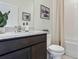 Charming bathroom with a granite countertop vanity, framed mirror, and shower-tub combination at 3066 Canopy Oak Blvd, Wildwood, FL 34785