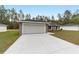 Charming single-story home featuring a wide driveway and attached two-car garage at 4386 Sw 158 Ct, Ocala, FL 34481