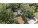 Aerial view of a house with meticulously designed landscaping in a serene, wooded neighborhood at 4701 Nw 60Th Terrace, Ocala, FL 34482