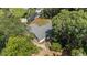 View of a home with a unique roof design and landscaped yard surrounded by lush greenery at 4701 Nw 60Th Terrace, Ocala, FL 34482