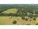 An aerial view capturing the property's layout with verdant fields, interspersed trees, and a sense of natural openness at 4701 Nw 60Th Terrace, Ocala, FL 34482