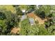 An aerial view features a landscaped home surrounded by trees and green lawns at 4701 Nw 60Th Terrace, Ocala, FL 34482