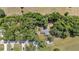 An aerial shot of a home nestled among trees, showing its roof and driveway at 4701 Nw 60Th Terrace, Ocala, FL 34482