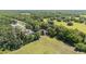 Aerial view showcasing the property's layout, surrounded by lush greenery, and neighboring homes, in a serene location at 4701 Nw 60Th Terrace, Ocala, FL 34482
