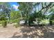 Serene backyard featuring mature trees with Spanish moss, manicured bushes, and natural ground cover at 4701 Nw 60Th Terrace, Ocala, FL 34482