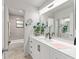 Bathroom with a large mirror, a marble-look vanity and access to the shower and toilet at 4701 Nw 60Th Terrace, Ocala, FL 34482