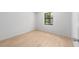 Bedroom features wood-look flooring and a window to allow natural light in the room at 4701 Nw 60Th Terrace, Ocala, FL 34482