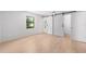 Bright bedroom features wood-look flooring, natural light, and a closet with sliding barn doors at 4701 Nw 60Th Terrace, Ocala, FL 34482
