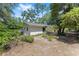 The backyard exterior of home with mature trees offers privacy and potential for outdoor enjoyment at 4701 Nw 60Th Terrace, Ocala, FL 34482
