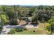 Home with mature trees and a landscaped yard along a residential street in a wooded neighborhood at 4701 Nw 60Th Terrace, Ocala, FL 34482
