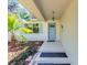 Inviting front entryway with a charming blue door and neat landscaping features at 4701 Nw 60Th Terrace, Ocala, FL 34482