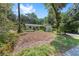 Single-story home with attractive landscaping and a tree-lined yard and front lawn at 4701 Nw 60Th Terrace, Ocala, FL 34482